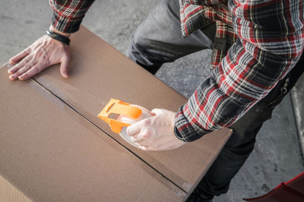 Mover Sealing a Box Before Transportation